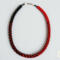 Handmade Crimson Noir Kumihimo beaded necklace featuring red and black glass seed beads with silver clasp on light background